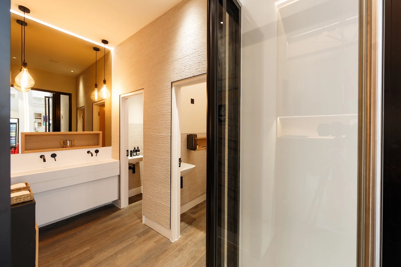 Warm lighting, a large mirror and a fitted vanity in the Chabad HGS washroom