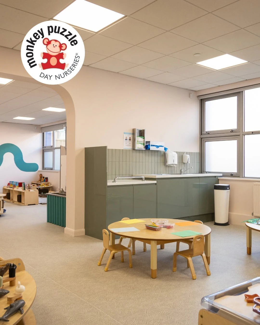 Child-height wash area, round table and nursery storage