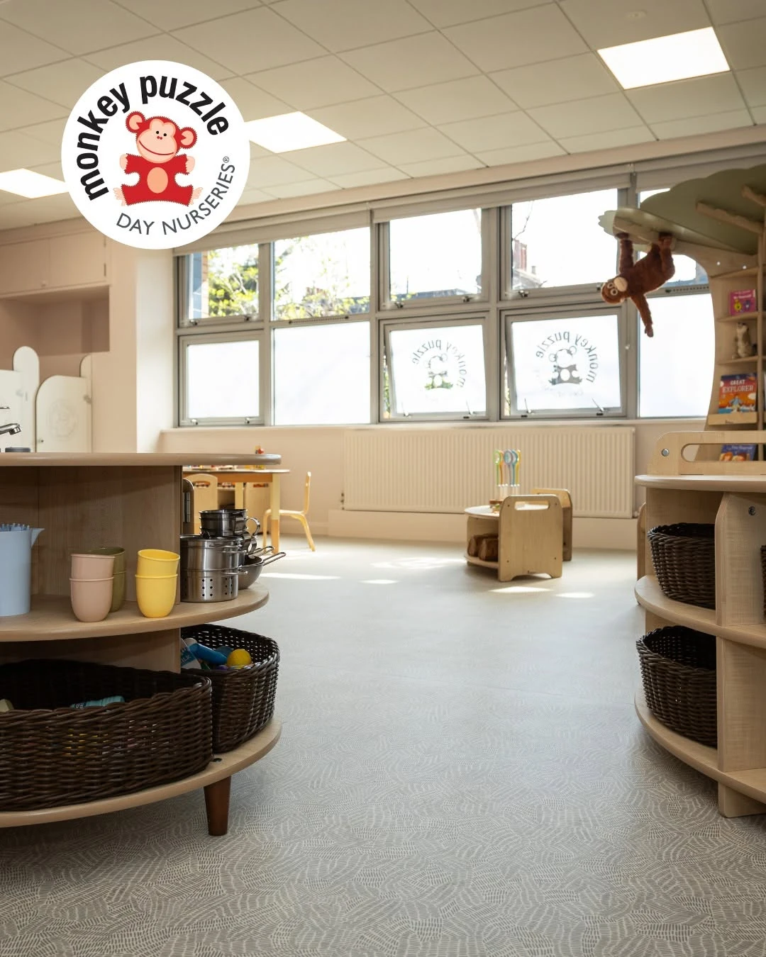 Low timber play furniture beside the nursery room windows
