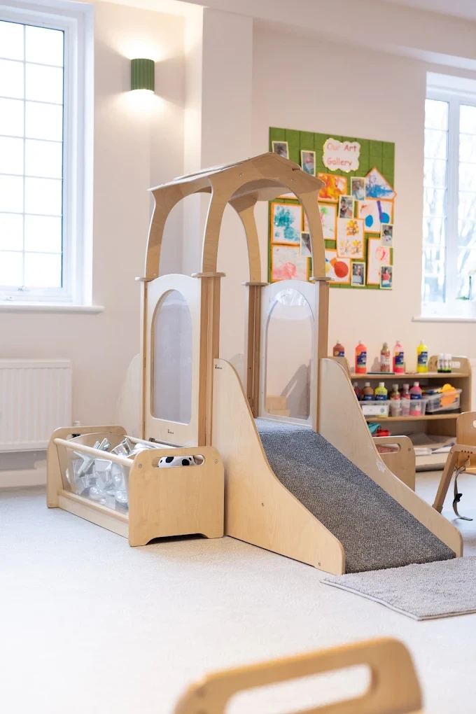 Indoor timber climbing frame and slide in the Ealing nursery