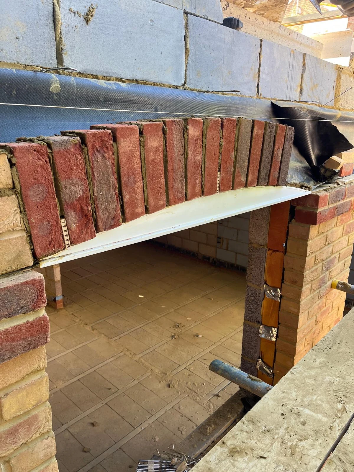 Brickwork detailing above a window opening.