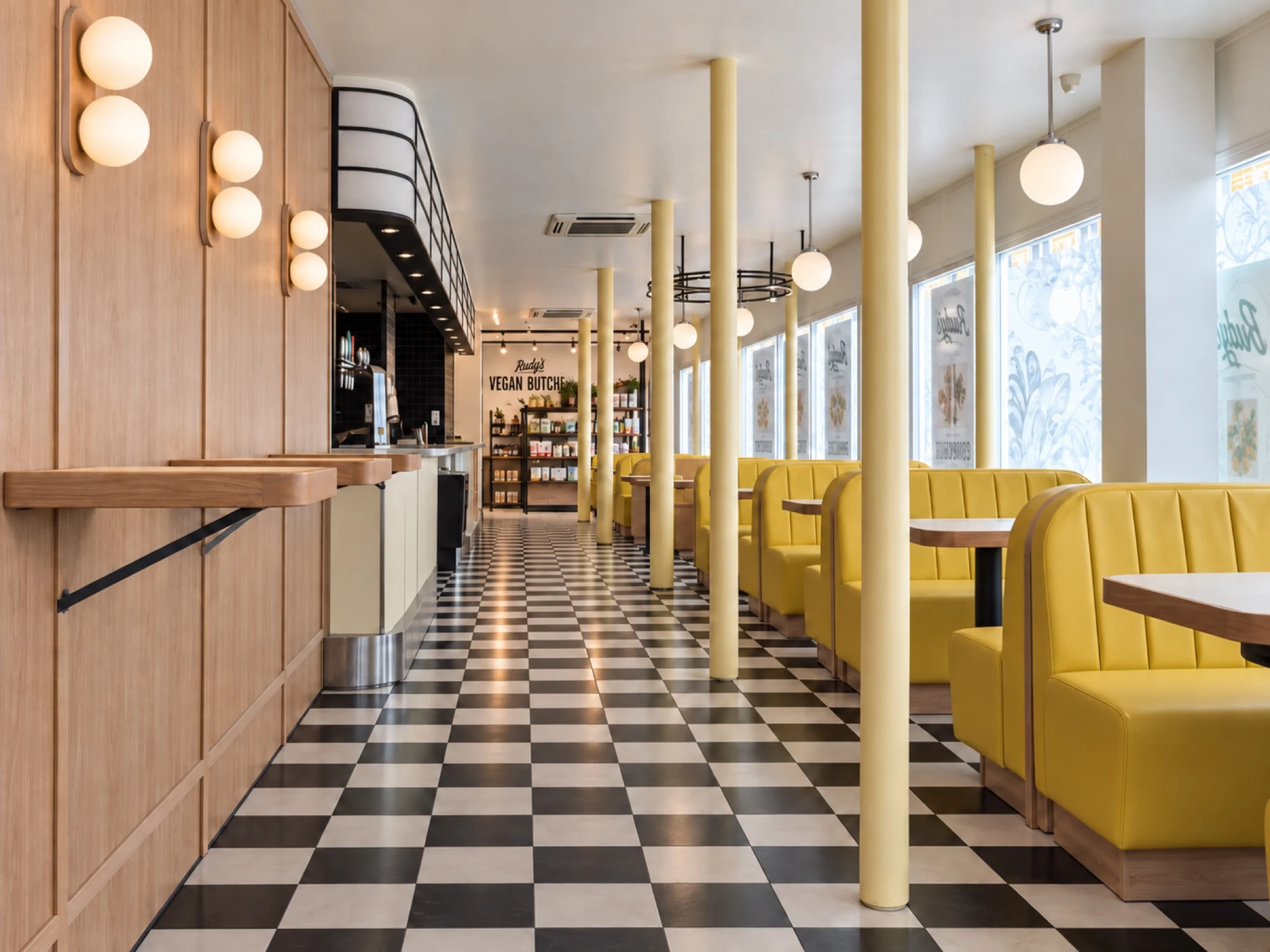 The dining aisle with booth seating beside the windows.