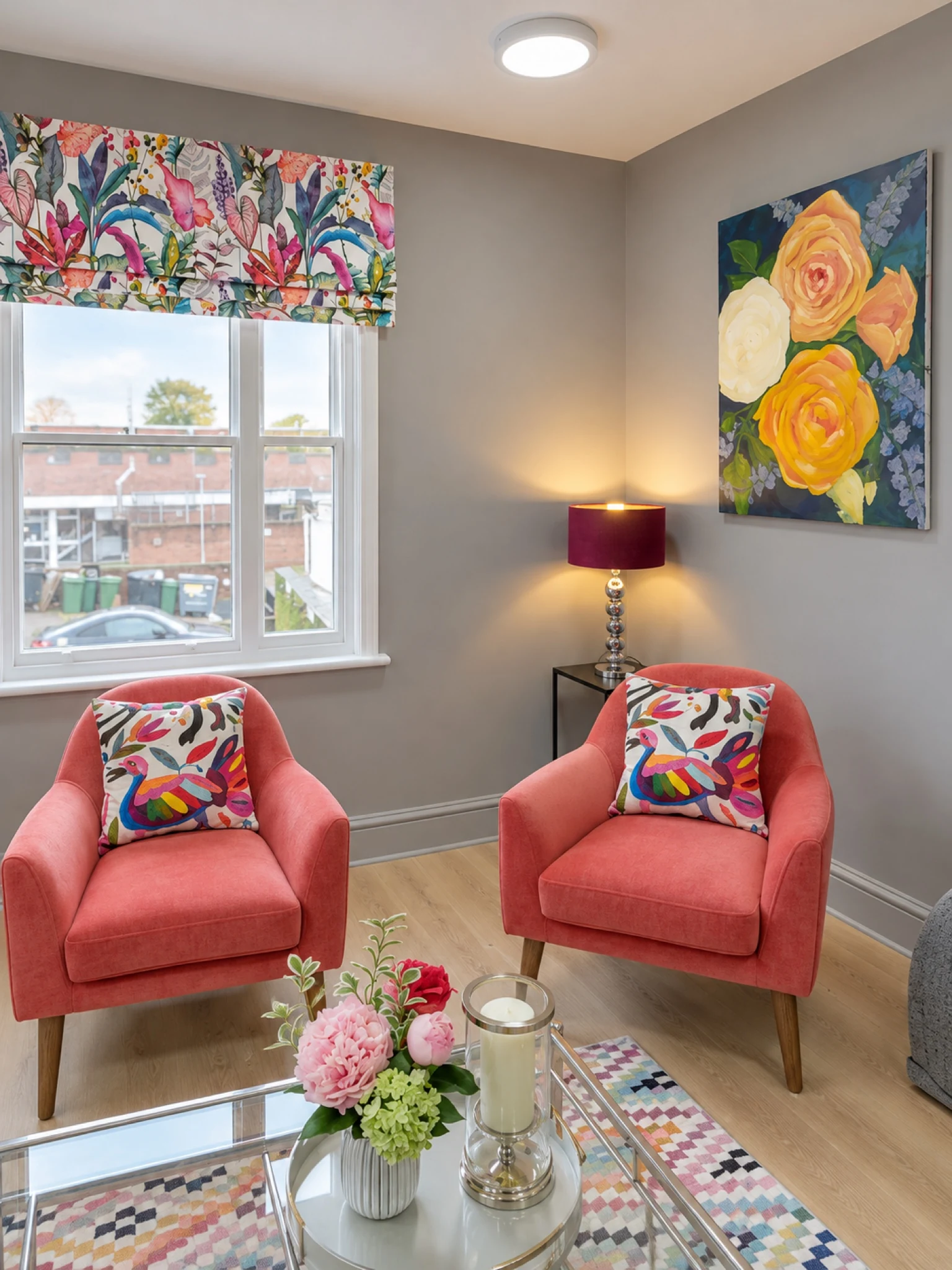 A light-filled sitting room with coral chairs.