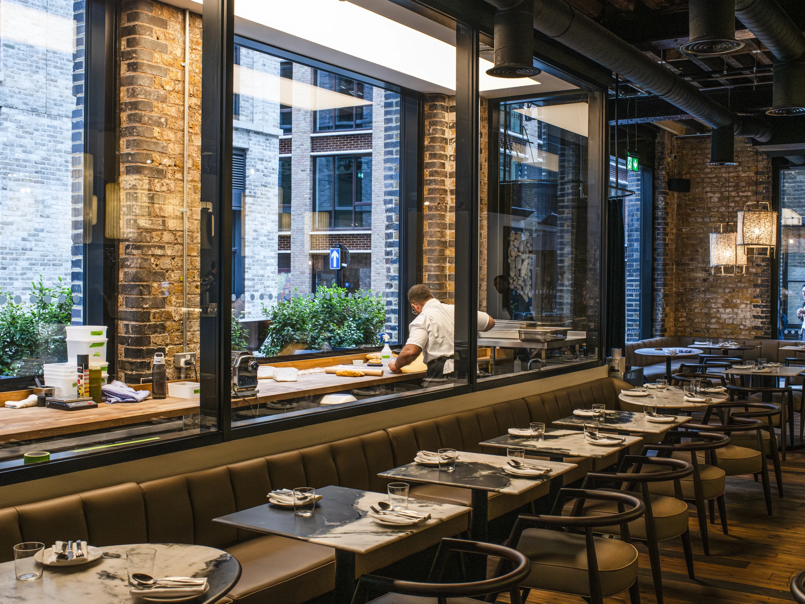 Sunlit tables, exposed brick and tall windows in Osteria Angelina, Spitalfields